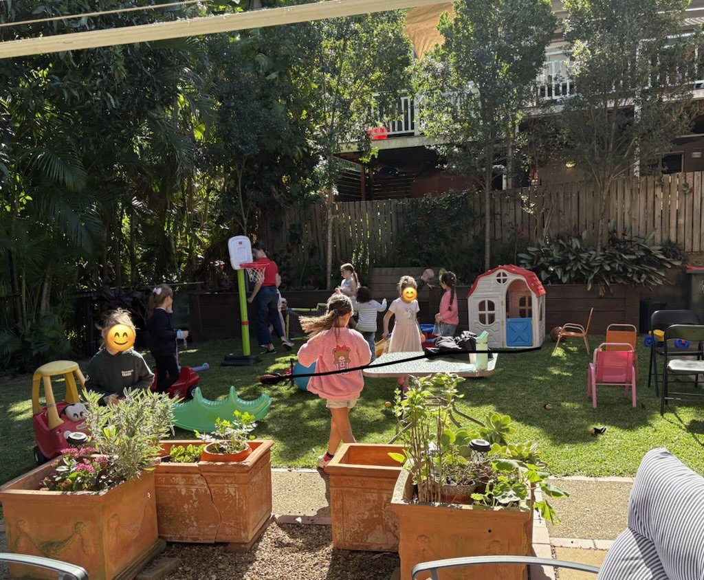 Backyard party setup with kids playing